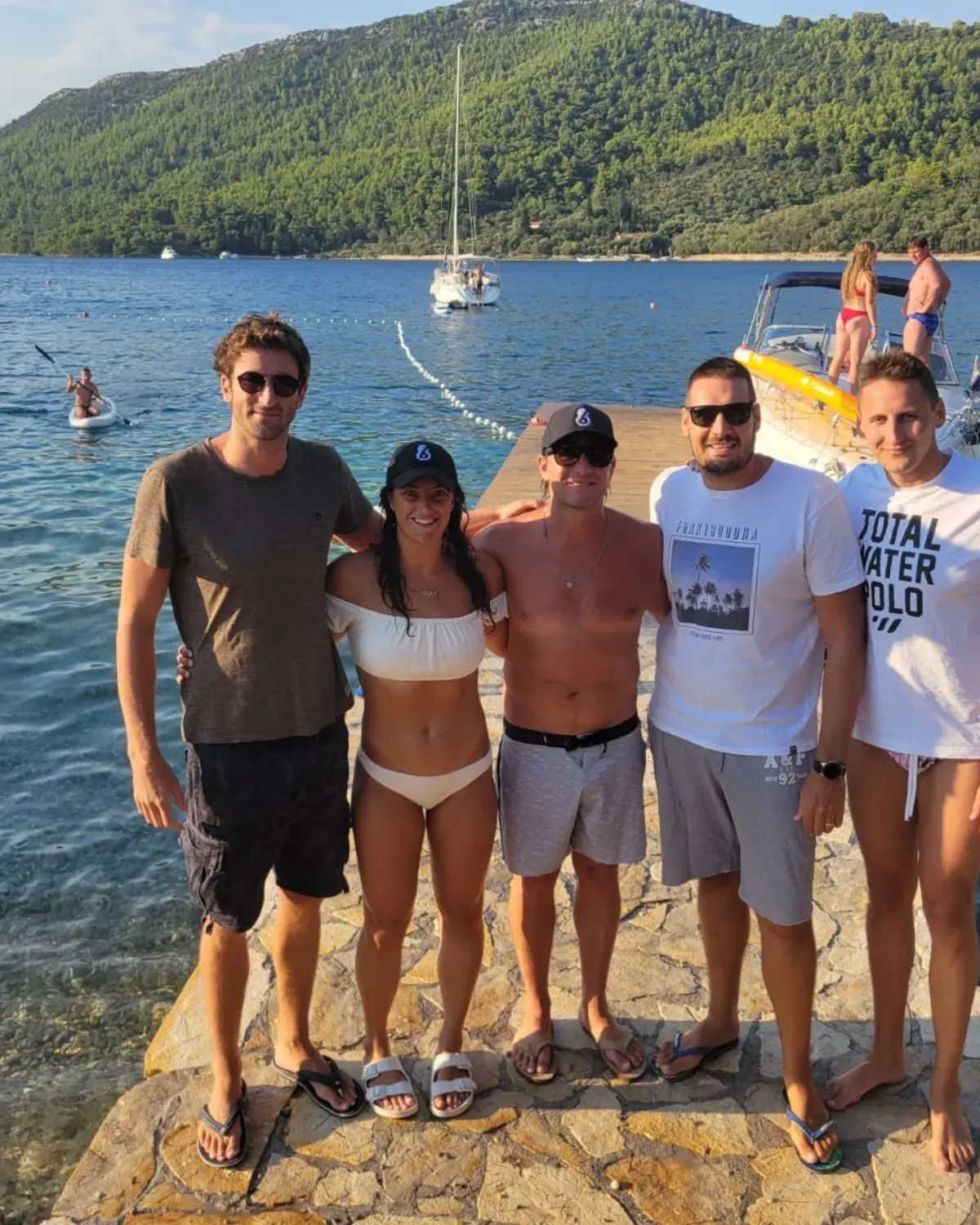Campers with their coaches by the water
