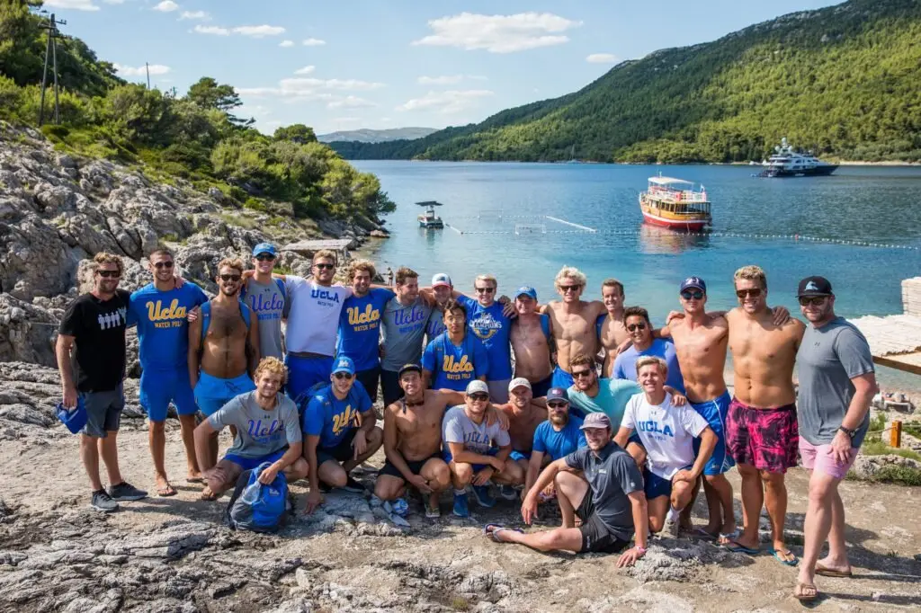 A large group of campers and coaches by the sea