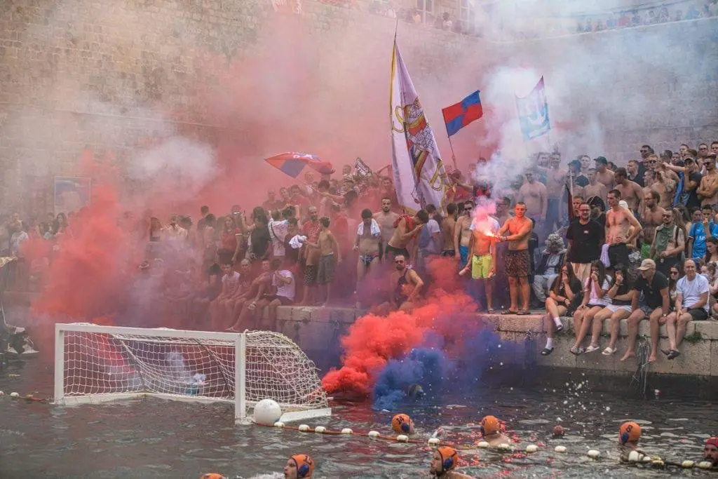 Fans with flares and flags at a Wild League final